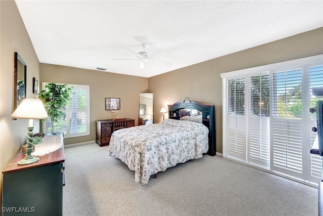 carpeted bedroom featuring a textured ceiling and ceiling fan