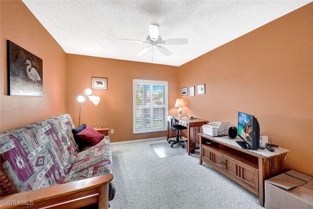 carpeted office with a textured ceiling and ceiling fan