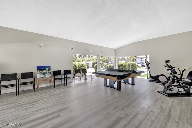 playroom with vaulted ceiling, billiards, and light wood-type flooring