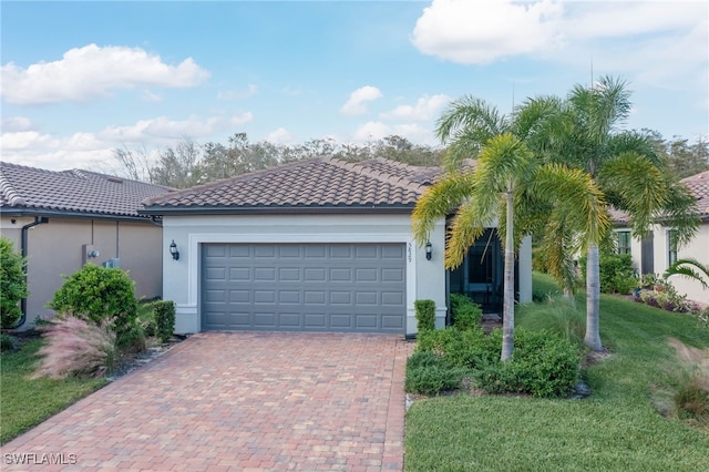 mediterranean / spanish-style house with a front lawn and a garage