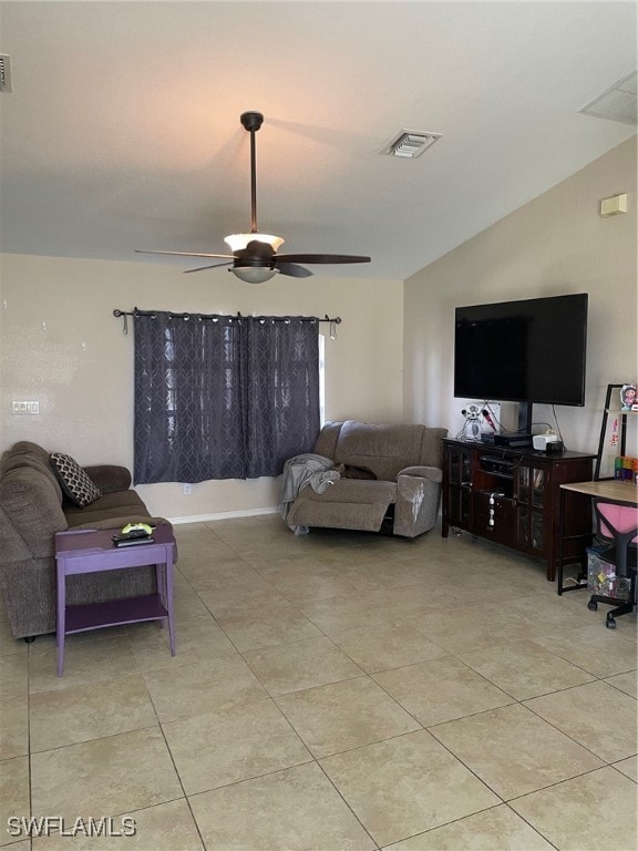 living room featuring lofted ceiling, light tile patterned floors, and ceiling fan