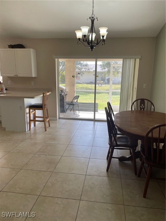 dining room with light tile patterned flooring and an inviting chandelier