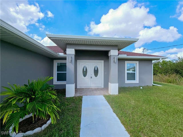 entrance to property with a lawn