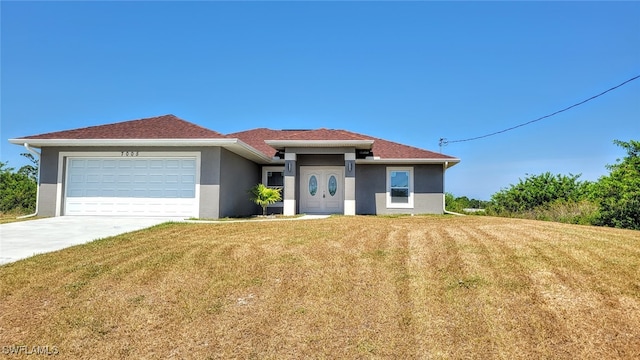 view of front facade with a front yard and a garage