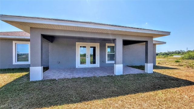 back of house with a yard and french doors