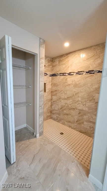 bathroom with tiled shower