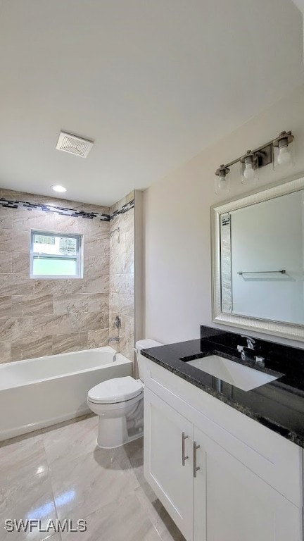 full bathroom with vanity, tiled shower / bath combo, and toilet