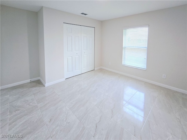 unfurnished bedroom with a closet