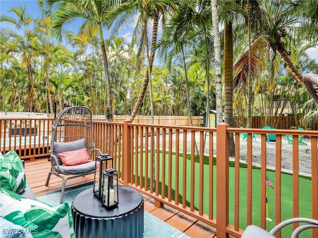 wooden terrace featuring a lawn