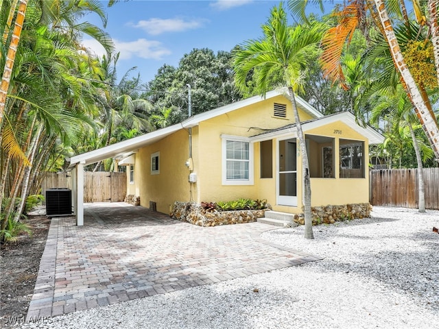 view of front of house with a patio and cooling unit