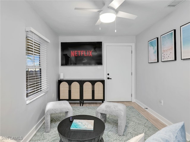 sitting room featuring hardwood / wood-style floors and ceiling fan