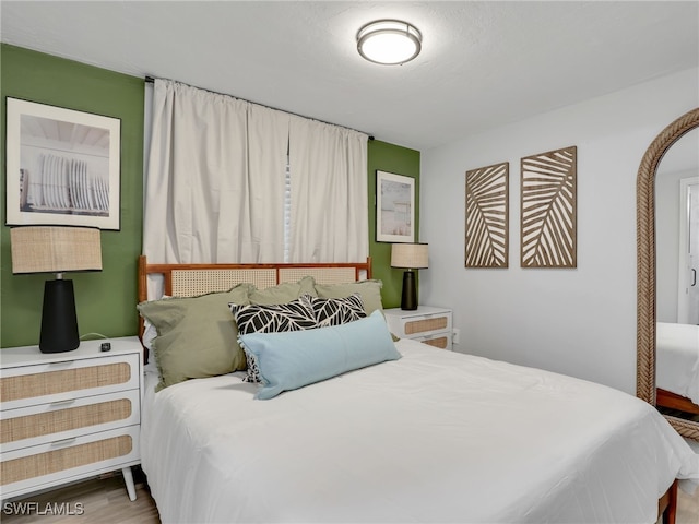 bedroom with wood-type flooring