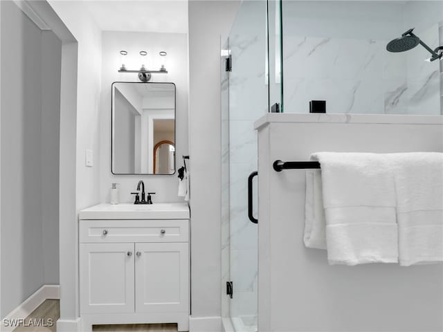 bathroom with vanity, hardwood / wood-style floors, and a shower with shower door