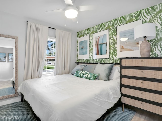 bedroom with hardwood / wood-style floors and ceiling fan