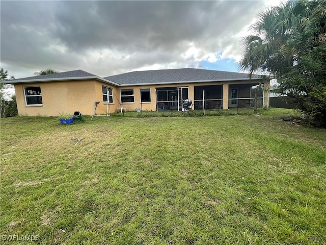 rear view of property with a yard