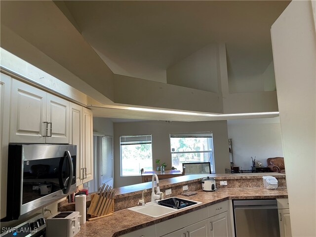 kitchen featuring white cabinets, stainless steel appliances, and sink