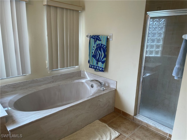 bathroom with plus walk in shower and tile patterned flooring