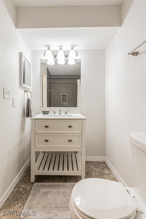 bathroom with toilet and vanity