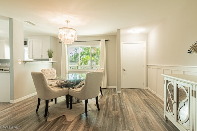 dining area featuring an inviting chandelier and dark hardwood / wood-style floors