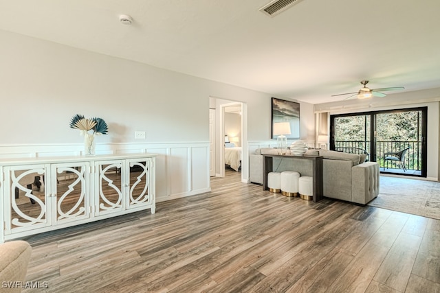 unfurnished living room with ceiling fan and light wood-type flooring