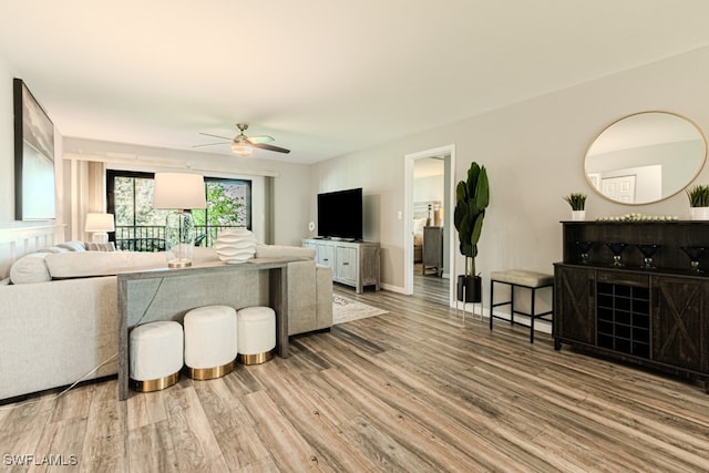 living room with ceiling fan and hardwood / wood-style floors