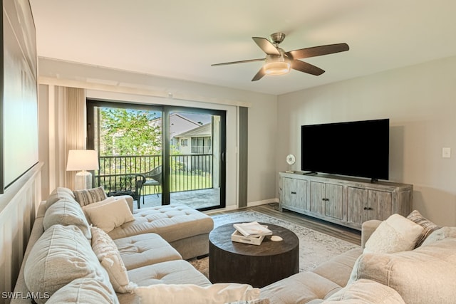 living room featuring ceiling fan and light hardwood / wood-style floors