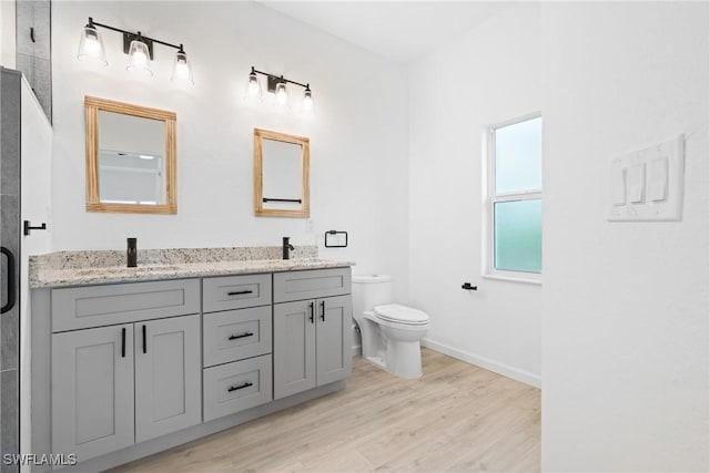 833 Newell St E, Lehigh Acres, FL 33974 - full bathroom featuring double vanity, wood finished floors, and a shower