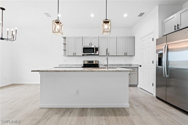 833 Newell St E, Lehigh Acres, FL 33974 - kitchen featuring appliances with stainless steel finishes, light wood-style flooring, gray cabinets, a chandelier, and recessed lighting