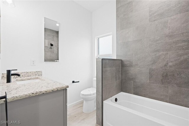833 Newell St E, Lehigh Acres, FL 33974 - bathroom featuring vanity, a tub, wood finished floors, and a shower