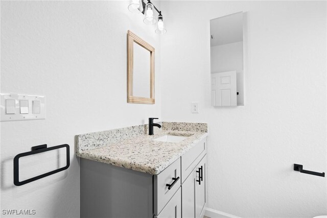 833 Newell St E, Lehigh Acres, FL 33974 - bathroom with vanity and baseboards
