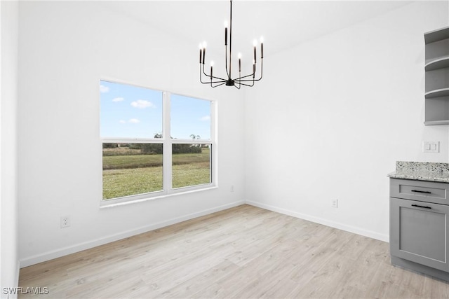 833 Newell St E, Lehigh Acres, FL 33974 - unfurnished dining area featuring a chandelier and light wood finished floors