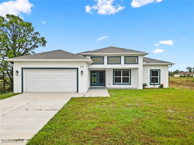 prairie-style house with a garage and a front lawn