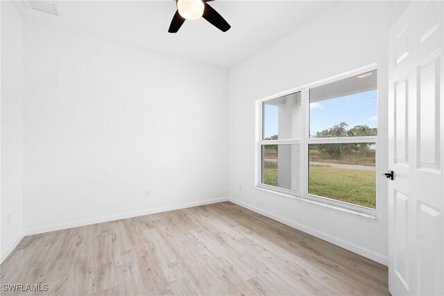 833 Newell St E, Lehigh Acres, FL 33974 - spare room with wood finished floors and a ceiling fan