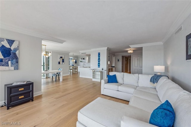 4031 Gulf Shore Blvd N Unit 95, Naples, FL 34103 - living area featuring a chandelier, light wood-type flooring, crown molding, and baseboards