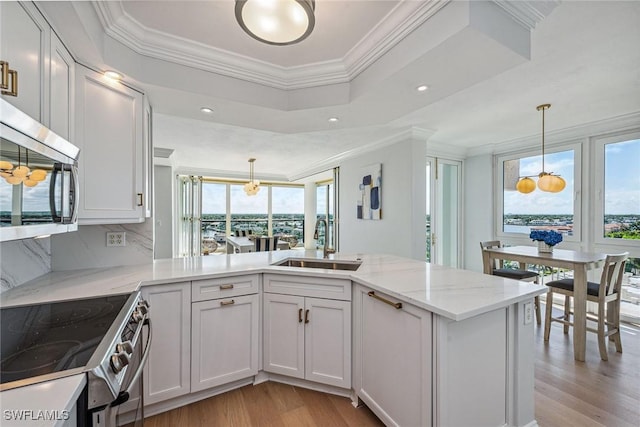 4031 Gulf Shore Blvd N Unit 95, Naples, FL 34103 - kitchen featuring a sink, stainless steel appliances, light wood-style floors, crown molding, and light stone countertops