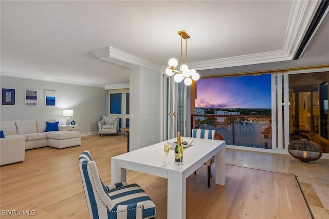 4031 Gulf Shore Blvd N Unit 95, Naples, FL 34103 - dining area featuring ornamental molding, wood finished floors, a chandelier, and baseboards