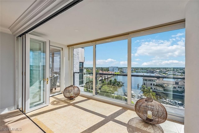 4031 Gulf Shore Blvd N Unit 95, Naples, FL 34103 - unfurnished sunroom with a water view, a wall of windows, inlaid floor details, and crown molding