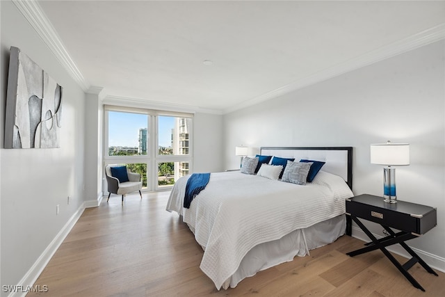 bedroom featuring light hardwood / wood-style floors and ornamental molding