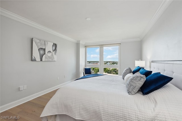 bedroom featuring wood-type flooring and ornamental molding