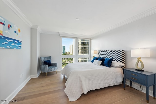 bedroom with light hardwood / wood-style flooring and ornamental molding