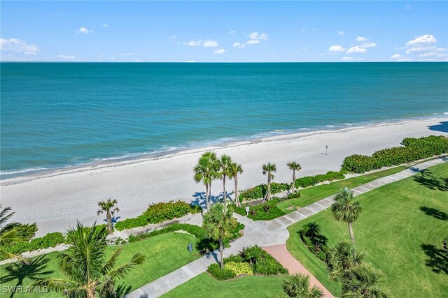 bird's eye view with a water view and a beach view