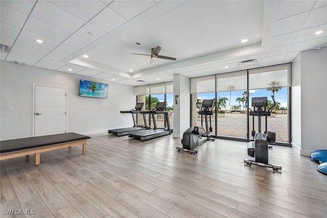 4031 Gulf Shore Blvd N Unit 95, Naples, FL 34103 - workout area featuring a raised ceiling, wood finished floors, baseboards, a ceiling fan, and floor to ceiling windows