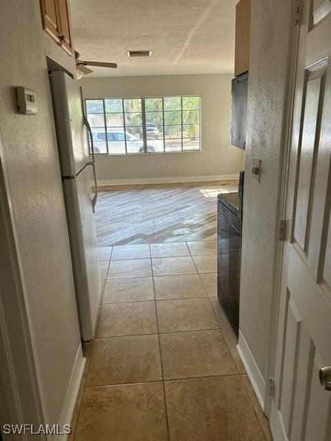 hallway with light tile patterned flooring