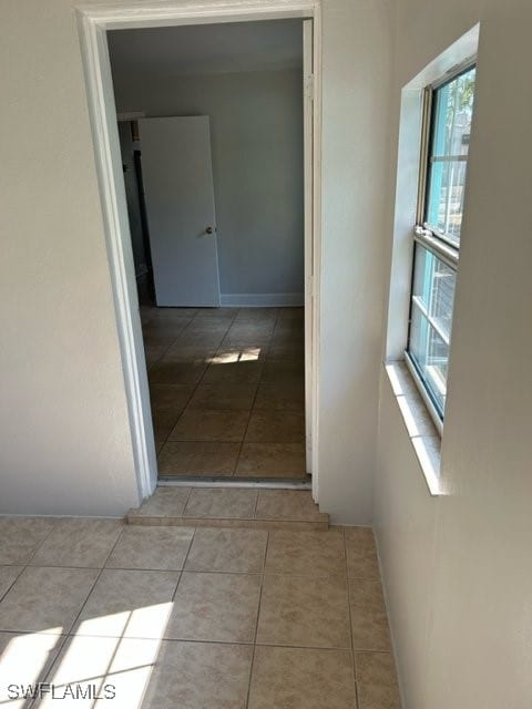 corridor featuring light tile patterned flooring