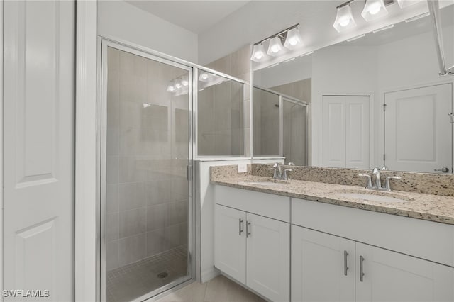 bathroom featuring vanity and a shower with door