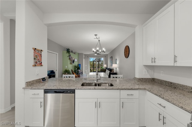 kitchen with sink, dishwasher, white cabinetry, and light stone counters