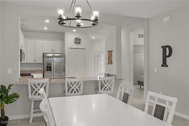 dining space with light tile patterned flooring and sink