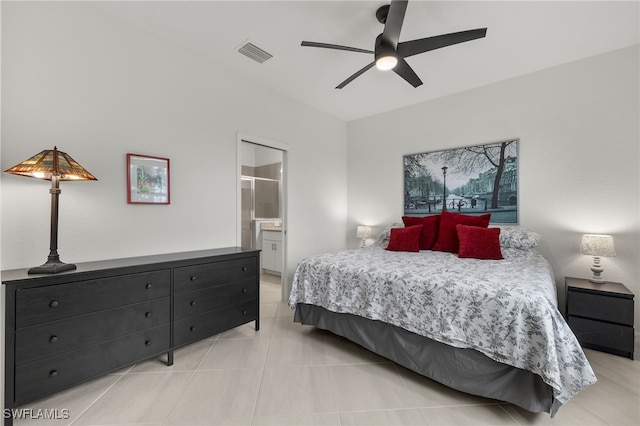 tiled bedroom with ensuite bath and ceiling fan