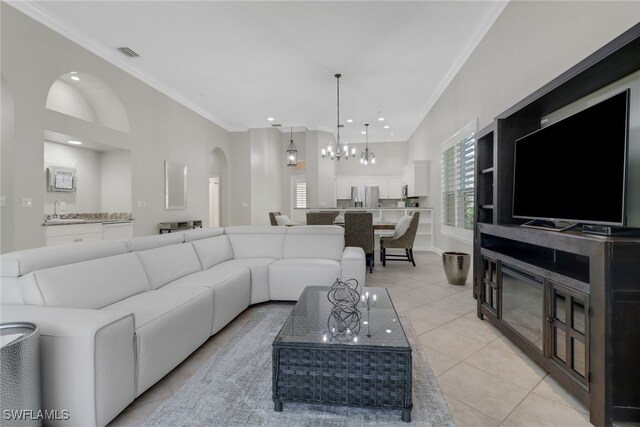 tiled living room with an inviting chandelier, ornamental molding, and sink