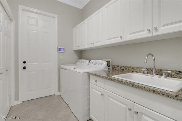 laundry room featuring sink, cabinets, independent washer and dryer, light tile patterned floors, and ornamental molding